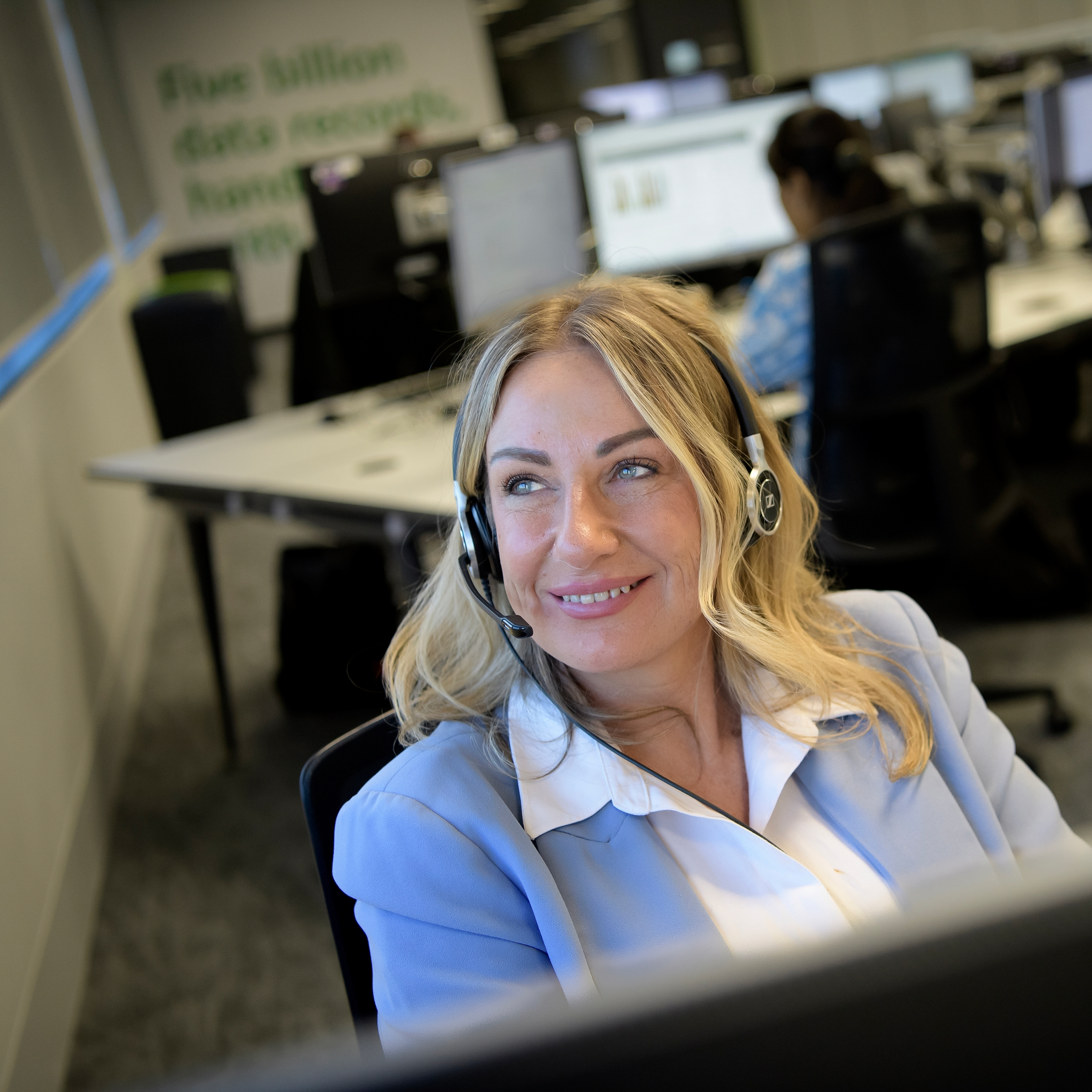 Person wearing headset working at desk in office