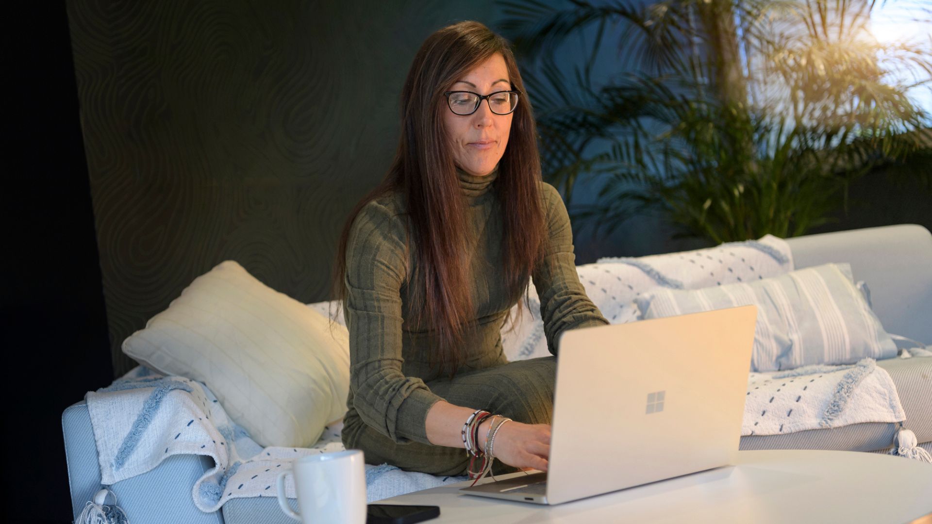 A woman typing on a laptop.