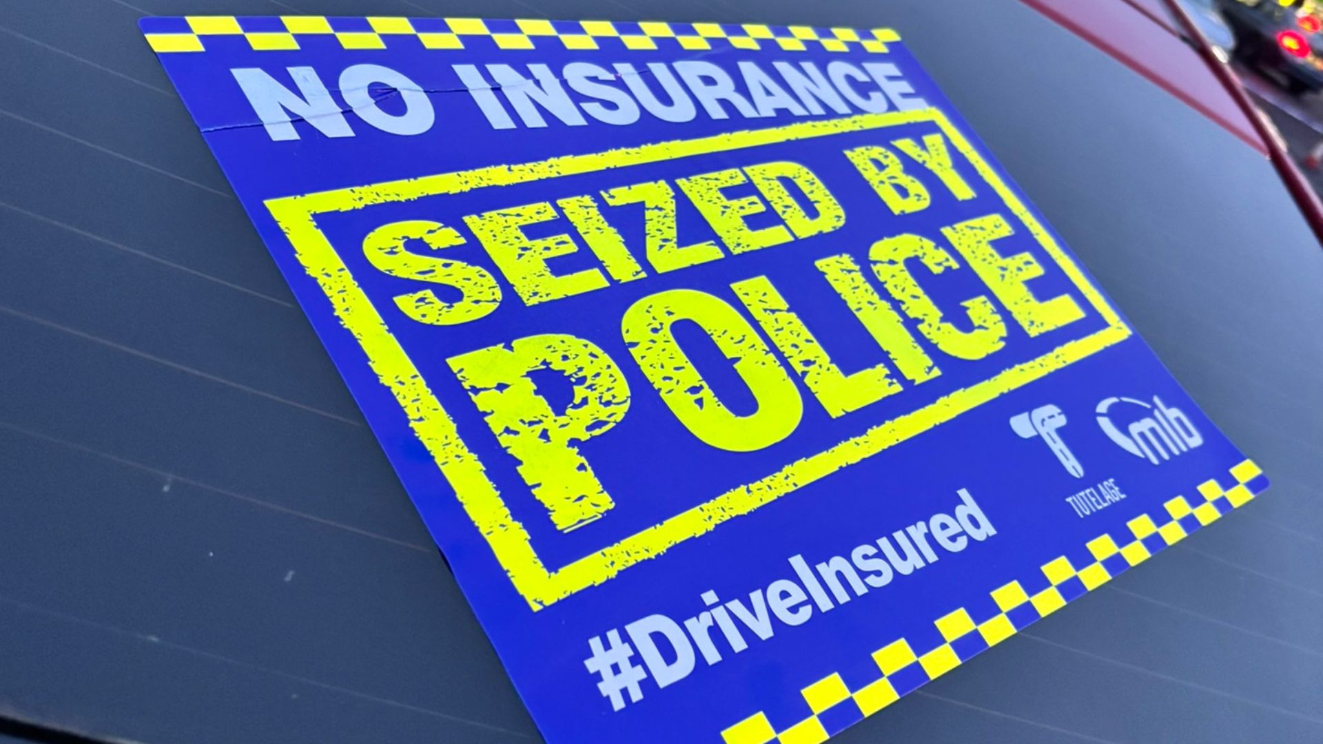 Close up photo of a seized by police sticker on a car window.