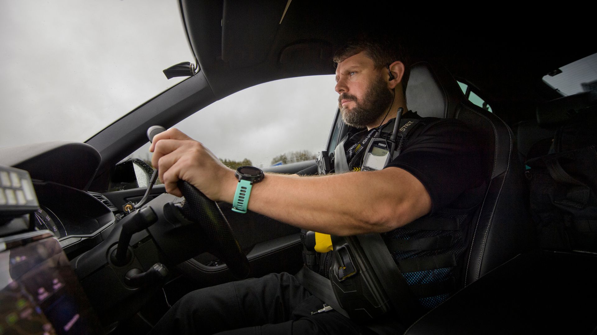Police officer in car driving 