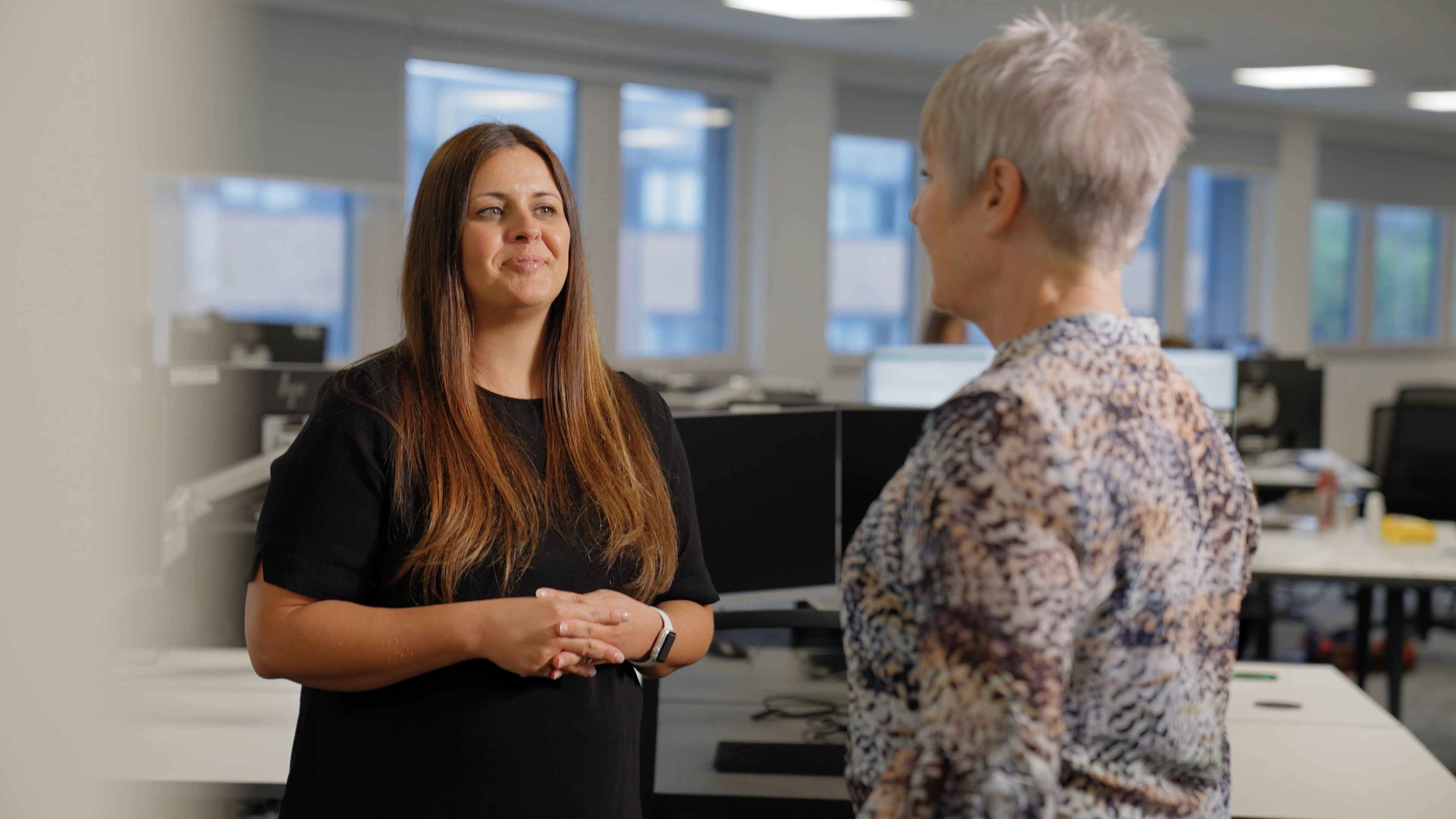 Two women talking to each other.