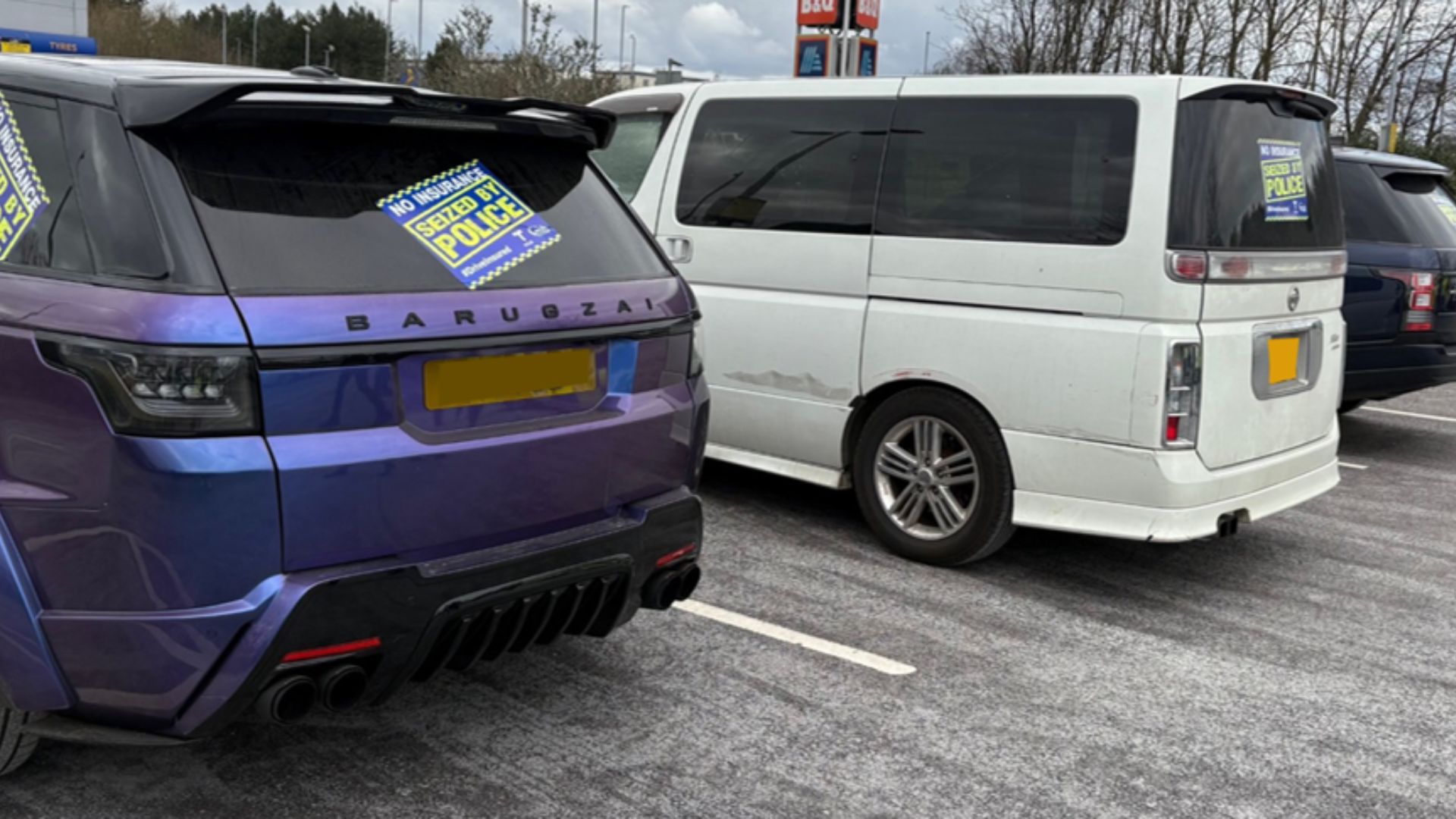 Three cars seized for no insurance with police seizure stickers on them.